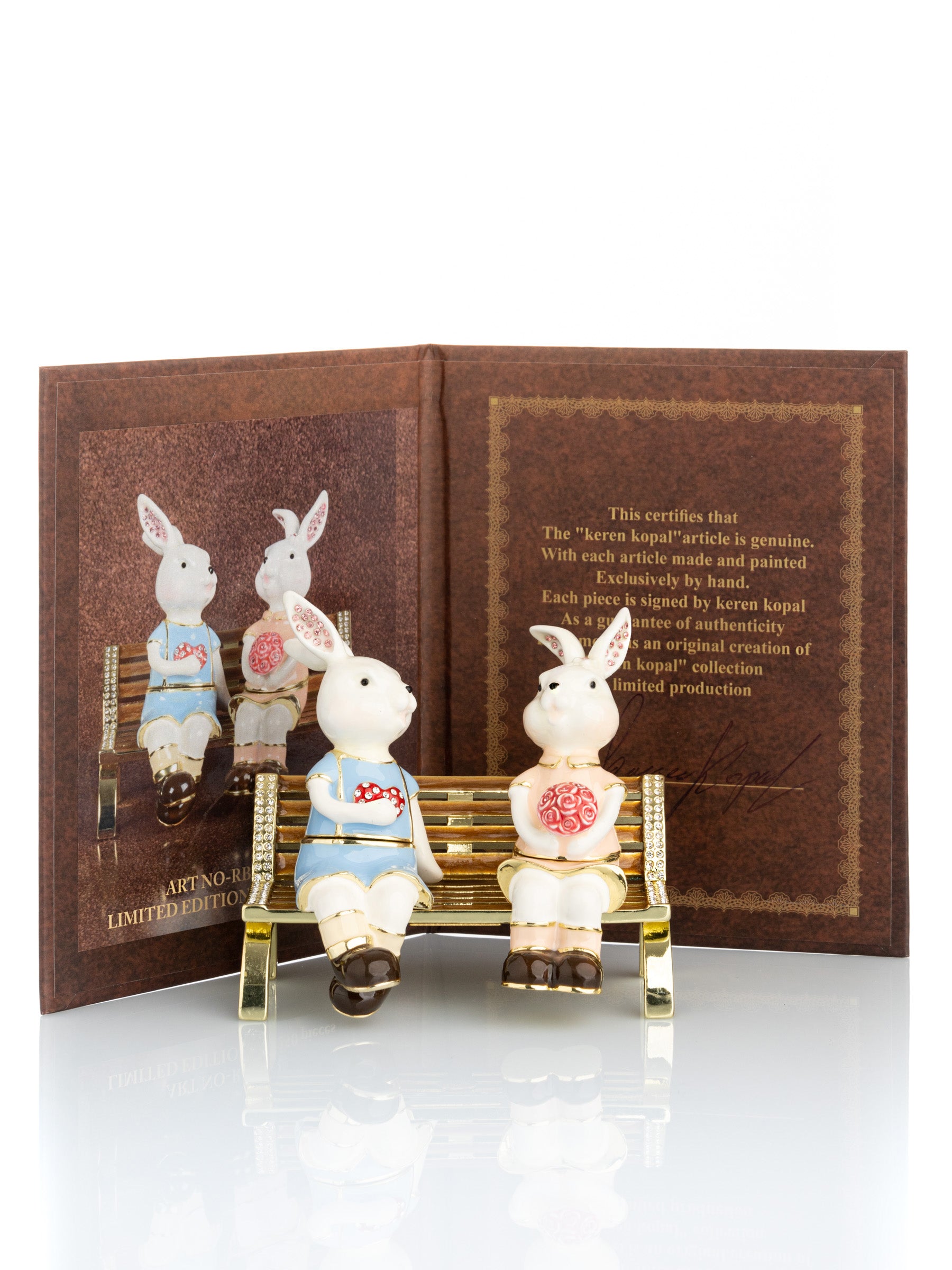 Keren Kopal 2 bunnies in love sitting on a bench, valentine flowers and chocolates