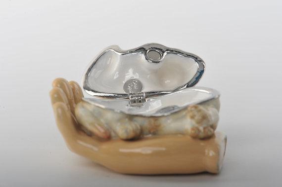 Keren Kopal Zodiac Dog Laying on Hand